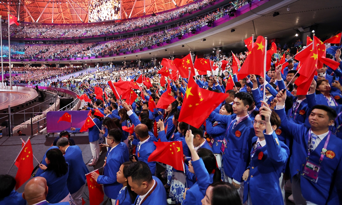 Members of the Chinese delegation wave the Chinese national flags at the opening ceremony of the 19th Asian Games on September 23, 2023, in Hangzhou, East China's Zhejiang Province. Photo: VCG