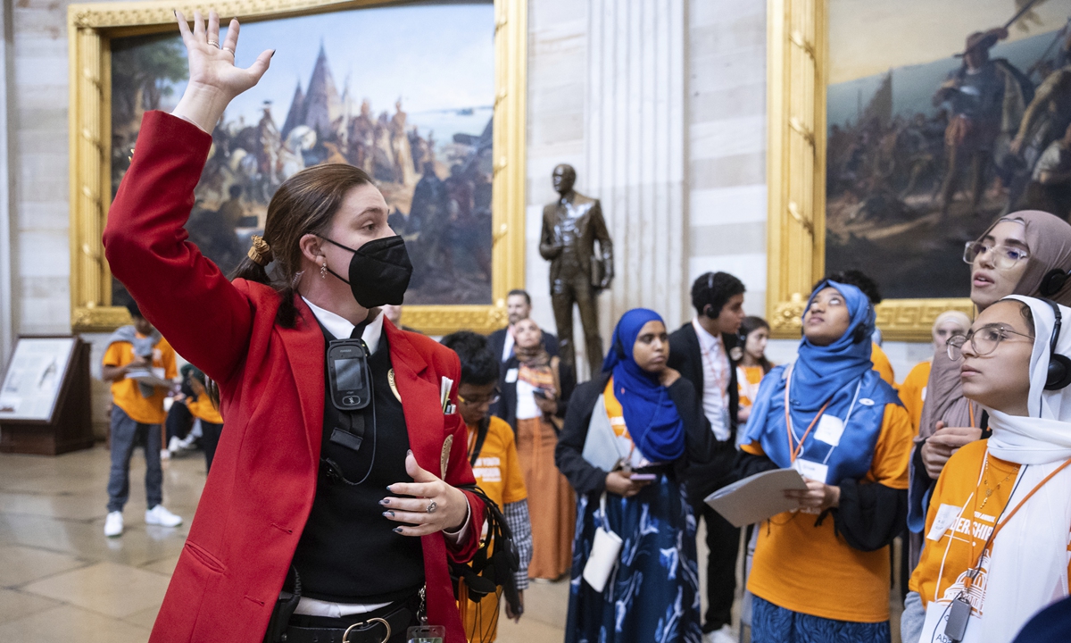 A US Capitol tour guide gives visitors a tour of the Capitol Rotunda on September 25, 2023. The guides, who wear distinctive red coats, are among workers who would be furloughed in the event of a government shutdown.Photo:VCG