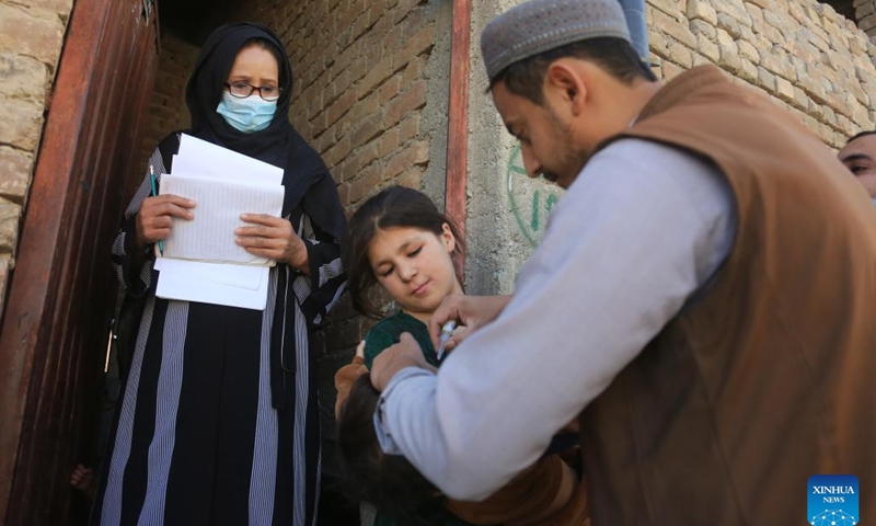 A health worker gives a dose of anti-polio vaccine to a child in Kabul, Afghanistan, Sept. 25, 2023. Afghanistan's Ministry of Public Health on Monday launched a nationwide anti-polio campaign in the war-ravaged country. During the four-day campaign, 11 million children under five will receive doses of the anti-polio vaccine for immunization as part of the country's efforts to eradicate the crippling disease among children, it said in a press release.(Photo: Xinhua)