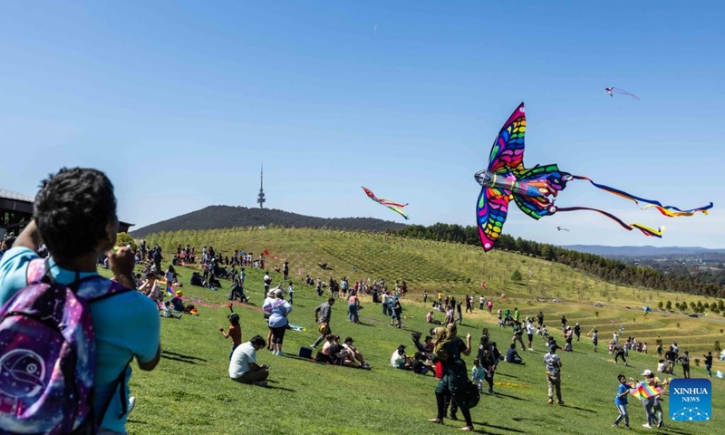 People gather for the Kite Fest at the National Arboretum Canberra in Canberra, Australia, Oct. 1, 2023. The National Arboretum Canberra held its yearly Kite Fest in Canberra on Sunday. Visitors can enjoy a variety of events such as pop-up food options, kite-making workshops, kite demonstrations, live entertainment and picnic. (Photo by Chu Chen/Xinhua)