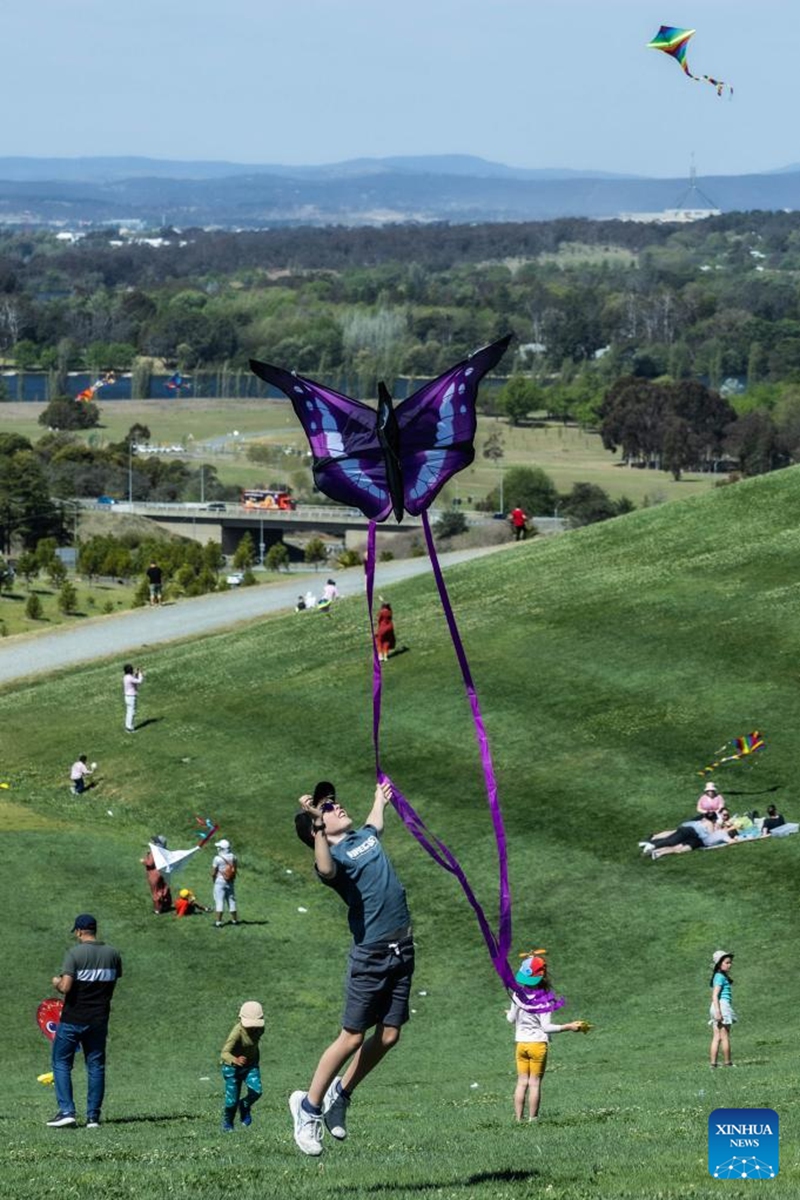 A boy enjoys himself during the Kite Fest at the National Arboretum Canberra in Canberra, Australia, Oct. 1, 2023. The National Arboretum Canberra held its yearly Kite Fest in Canberra on Sunday. Visitors can enjoy a variety of events such as pop-up food options, kite-making workshops, kite demonstrations, live entertainment and picnic. (Photo by Chu Chen/Xinhua)