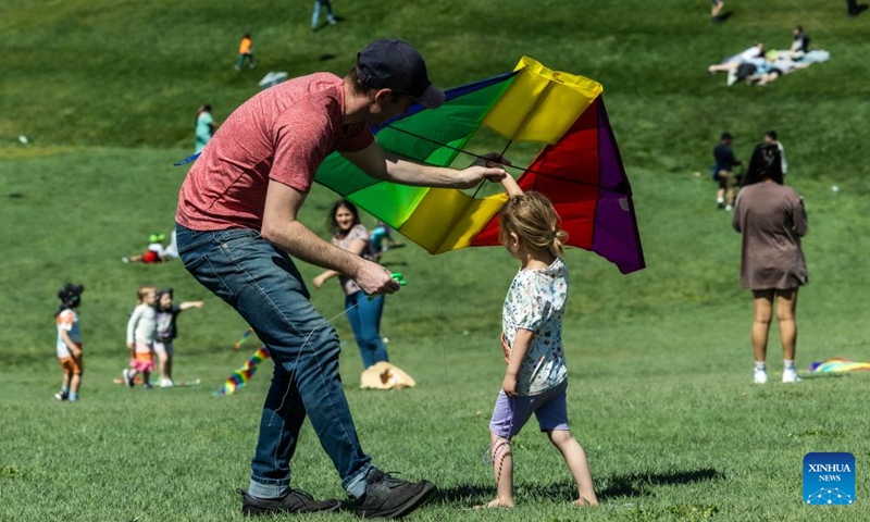 A man teaches his daughter how to fly a kite during the Kite Fest at the National Arboretum Canberra in Canberra, Australia, Oct. 1, 2023. The National Arboretum Canberra held its yearly Kite Fest in Canberra on Sunday. Visitors can enjoy a variety of events such as pop-up food options, kite-making workshops, kite demonstrations, live entertainment and picnic. (Photo by Chu Chen/Xinhua)