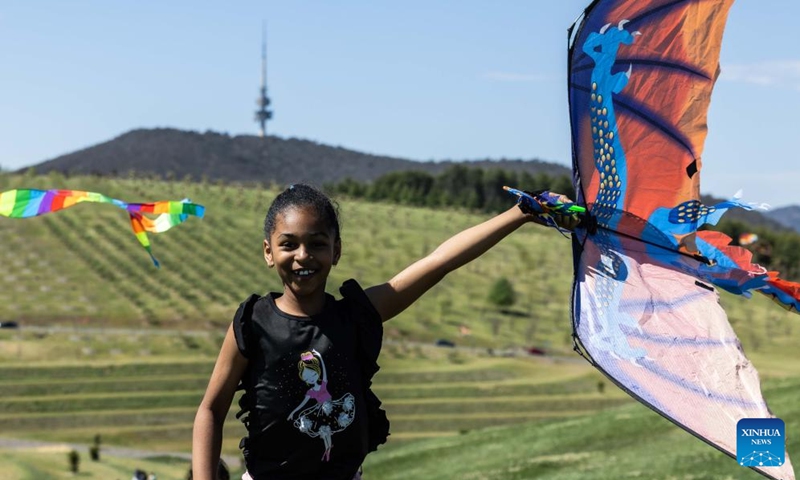 A child holds a kite during the Kite Fest at the National Arboretum Canberra in Canberra, Australia, Oct. 1, 2023. The National Arboretum Canberra held its yearly Kite Fest in Canberra on Sunday. Visitors can enjoy a variety of events such as pop-up food options, kite-making workshops, kite demonstrations, live entertainment and picnic. (Photo by Chu Chen/Xinhua)