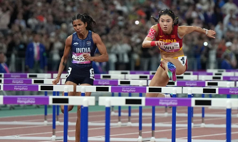 Wu Yanni (R) of China competes during the Women's 100m Hurdles Final of Athletics at the 19th Asian Games in Hangzhou, east China's Zhejiang Province, Oct 1, 2023. Photo: Xinhua
