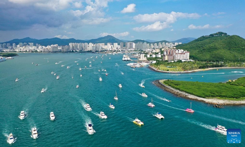 This aerial photo taken on Oct. 1, 2023 shows tourists going sailing in Sanya, south China's Hainan Province. As a popular tourist destination, Sanya is seeing a tourism boom during the National Day holiday. (Xinhua/Guo Cheng)