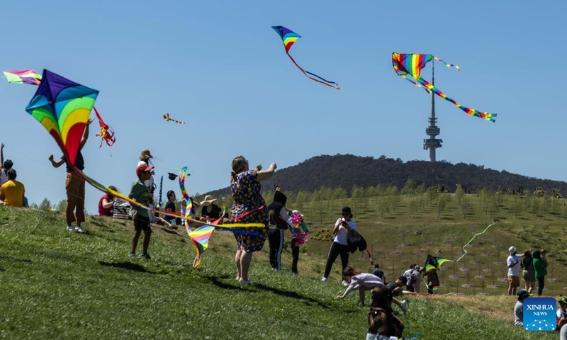 People gather for the Kite Fest at the National Arboretum Canberra in Canberra, Australia, Oct. 1, 2023. The National Arboretum Canberra held its yearly Kite Fest in Canberra on Sunday. Visitors can enjoy a variety of events such as pop-up food options, kite-making workshops, kite demonstrations, live entertainment and picnic. (Photo by Chu Chen/Xinhua)