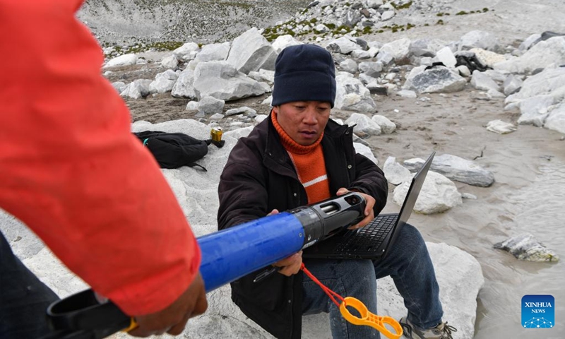 Members of a Chinese expedition team perform a real-time water quality check at a proglacial lake in the Mount Cho Oyu region on Oct. 1, 2023. An 18-member expedition team successfully reached on Sunday the summit of Mount Cho Oyu, also known as Mt. Qowowuyag, which soars to 8,201 meters above sea level, to carry out scientific research. It was the first time Chinese scientists scaled a peak exceeding 8,000 meters in altitude apart from Mt. Qomolangma, the world's highest summit. Photo: Xinhua
