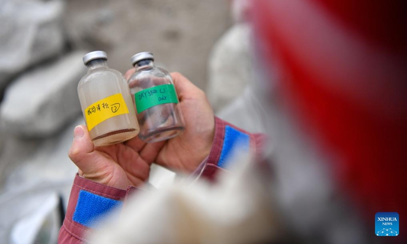 A member of a Chinese expedition team checks the water samples collected from a proglacial lake in the Mount Cho Oyu region on Oct. 1, 2023. An 18-member expedition team successfully reached on Sunday the summit of Mount Cho Oyu, also known as Mt. Qowowuyag, which soars to 8,201 meters above sea level, to carry out scientific research. It was the first time Chinese scientists scaled a peak exceeding 8,000 meters in altitude apart from Mt. Qomolangma, the world's highest summit. Photo: Xinhua