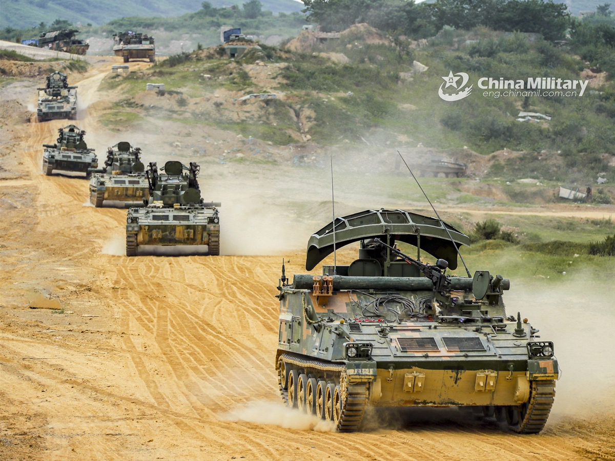 Armored vehicles attached to a brigade under the PLA 71st Group Army march on a mud road during a training exercise. The exercise was held in upper September with the purpose to assess the troops' ability to combat under emergence situation. (eng.chinamil.com.cn/Photo by Wan Zhiqi)