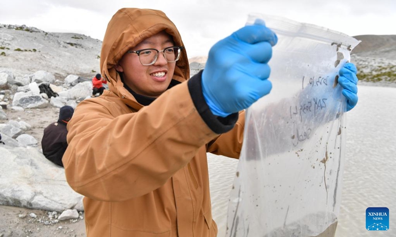 A member of a Chinese expedition team checks the samples collected from a proglacial lake in the Mount Cho Oyu region on Oct. 1, 2023. An 18-member expedition team successfully reached on Sunday the summit of Mount Cho Oyu, also known as Mt. Qowowuyag, which soars to 8,201 meters above sea level, to carry out scientific research. It was the first time Chinese scientists scaled a peak exceeding 8,000 meters in altitude apart from Mt. Qomolangma, the world's highest summit. Photo: Xinhua