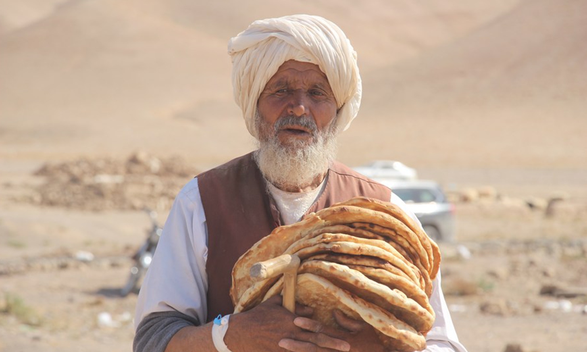 An old man holds pieces of naan, a kind of traditional bread, following earthquakes in Herat Province, Afghanistan, Oct. 11, 2023. (Photo by Mashal/Xinhua)



