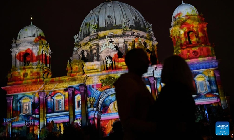 Visitors stand in front of the illuminated Berlin Cathedral during the 2023 Festival of Lights in Berlin, Germany, Oct. 6, 2023. Berlin on Friday turned into a city of light art with the opening of the 2023 Festival of Lights, which will last until Oct. 15. (Xinhua/Ren Pengfei)