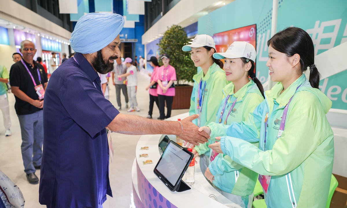  OCA acting president Raja Randhir Singh shakes hands with volunteers in the Athletes Village. Photo: hangzhou2022.cn 