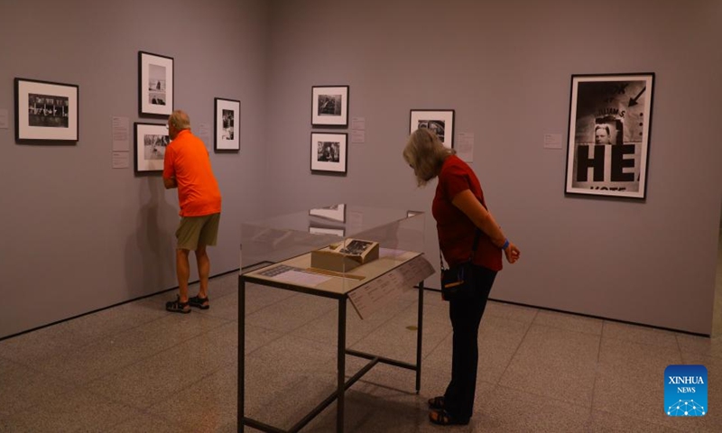 People attend the preview of a photo exhibition titled Robert Frank and Todd Webb: Across America, 1955 at the Museum of Fine Arts, Houston, Texas, the United States, on Oct. 6. 2023. A total of 100 photographs chart the cross-country journeys of two photographers, who each captured singular views of America in the mid-20th century, during the exhibition here from Oct. 8, 2023 to Jan. 7, 2024. (Xinhua/Xu Jianmei)