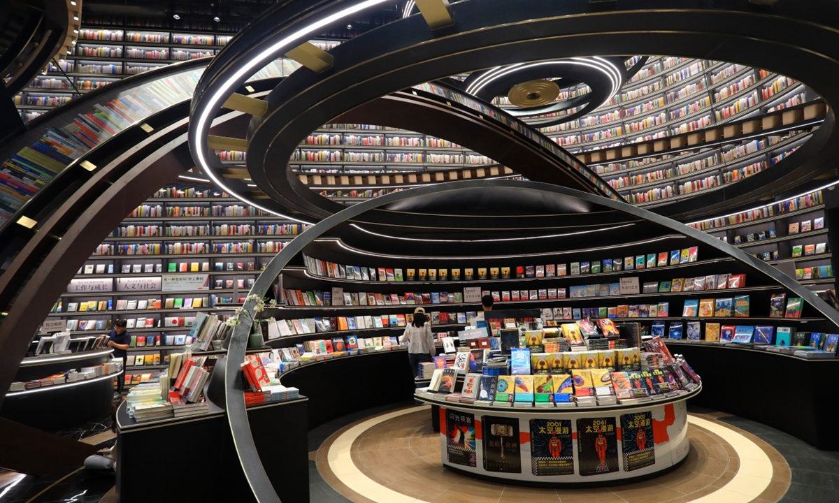 Customers read books at the Zhongshuge bookstore in Huaian, East China's Jiangsu Province, on October 15, 2023. Known as the most beautiful bookstore in Huaian, it has attracted many people with its sci-fi-like design. Photo: VCG
