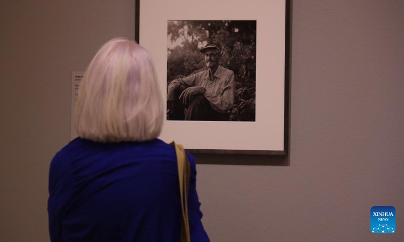 A visitor views a photograph at the preview of a photo exhibition titled Robert Frank and Todd Webb: Across America, 1955 at the Museum of Fine Arts, Houston, Texas, the United States, on Oct. 6. 2023. A total of 100 photographs chart the cross-country journeys of two photographers, who each captured singular views of America in the mid-20th century, during the exhibition here from Oct. 8, 2023 to Jan. 7, 2024. (Xinhua/Xu Jianmei)