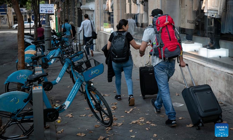 Tourists head to the airport in Jerusalem on Oct. 8, 2023. The Palestinian Islamic Resistance Movement (Hamas) on Saturday showered Israel with thousands of rockets in a rare surprise attack that was responded with massive Israeli airstrikes on Gaza and punitive measures, including power outages.(Photo: Xinhua)