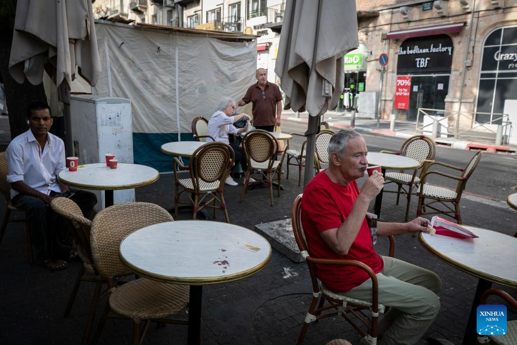 People have breakfast on a street in Jerusalem on Oct. 8, 2023. The Palestinian Islamic Resistance Movement (Hamas) on Saturday showered Israel with thousands of rockets in a rare surprise attack that was responded with massive Israeli airstrikes on Gaza and punitive measures, including power outages.(Photo: Xinhua)