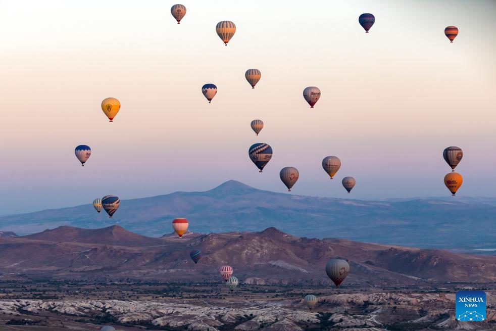 This photo taken on Oct. 8, 2023 shows hot air balloons flying over Cappadocia, Türkiye. Cappadocia is a popular tourist destination in central Türkiye known for its distinctive volcanic geographical formations and hot air balloon rides.(Photo: Xinhua)