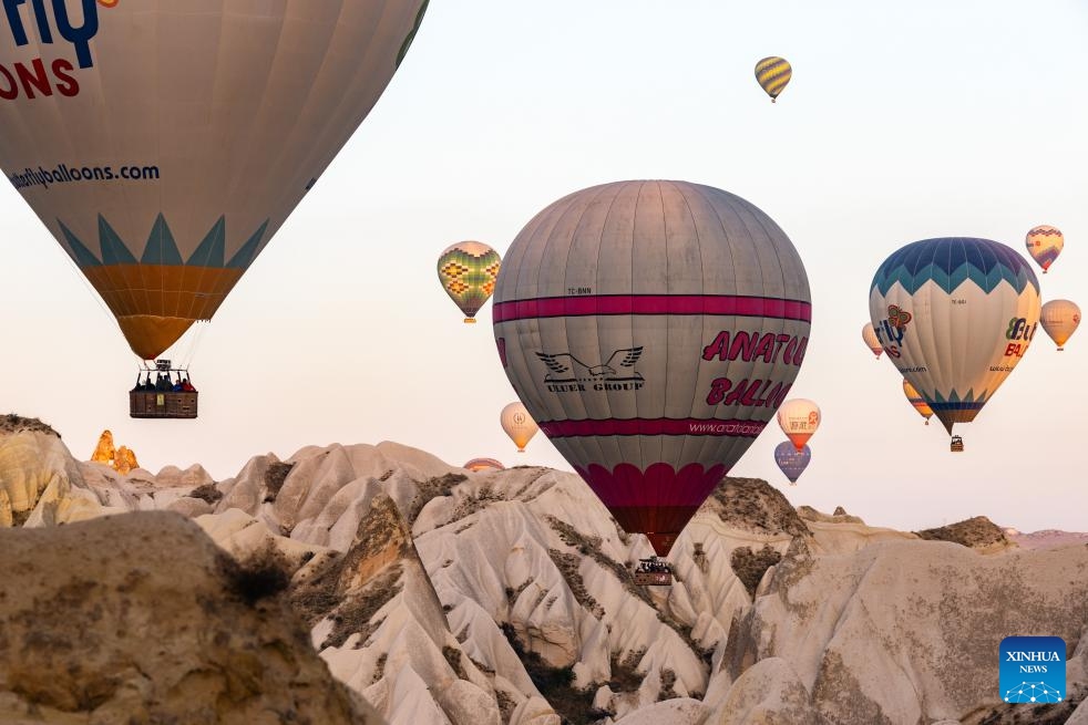 This photo taken on Oct. 8, 2023 shows hot air balloons flying over Cappadocia, Türkiye. Cappadocia is a popular tourist destination in central Türkiye known for its distinctive volcanic geographical formations and hot air balloon rides.(Photo: Xinhua)