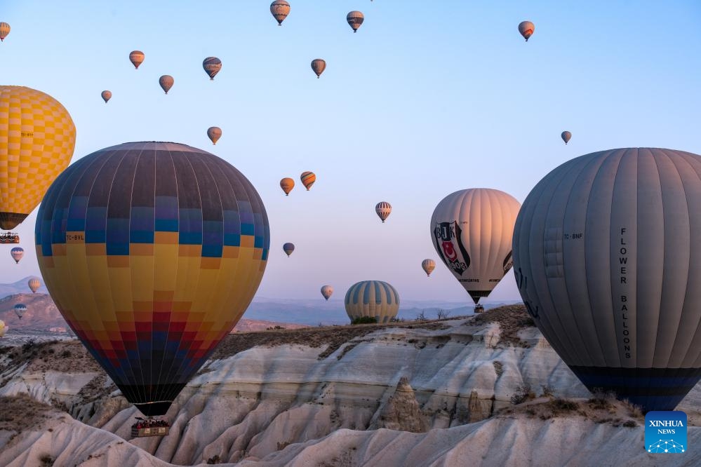 This photo taken on Oct. 8, 2023 shows hot air balloons flying over Cappadocia, Türkiye. Cappadocia is a popular tourist destination in central Türkiye known for its distinctive volcanic geographical formations and hot air balloon rides.(Photo: Xinhua)