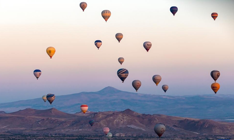 This photo taken on Oct. 8, 2023 shows hot air balloons flying over Cappadocia, Türkiye. Cappadocia is a popular tourist destination in central Türkiye known for its distinctive volcanic geographical formations and hot air balloon rides.(Photo: Xinhua)