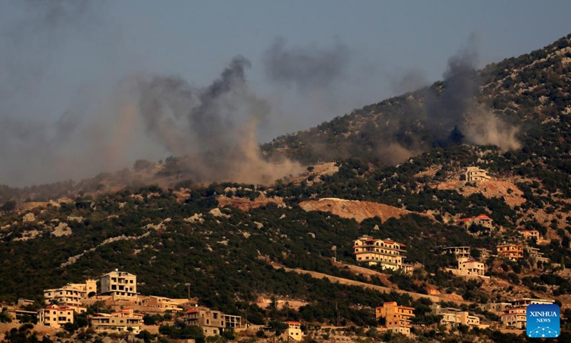This photo taken in the Lebanese town of Al-Marion shows smoke billowing following an Israeli missile bombardment on the town of Shebaa in southeast Lebanon, Oct. 14, 2023. A fighter with Hezbollah, a Lebanese military group, was killed in the Israeli attacks that targeted the Shebaa Farms on Saturday afternoon, a statement by the Shiite group reported.(Photo:Xinhua)