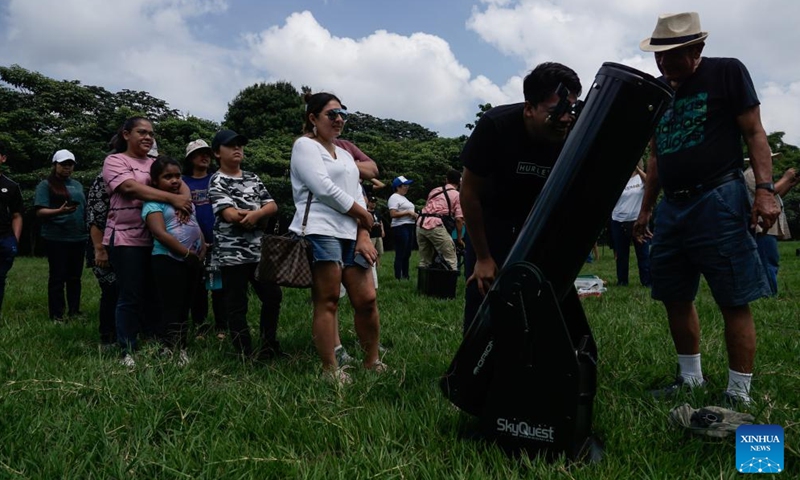 People observe a solar eclipse in San Salvador, El Salvador, Oct. 14, 2023. (Photo:Xinhua)