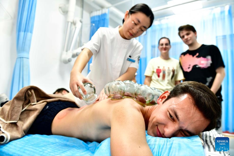 A Turkmen student from the College of International Exchange of the Shandong University of Science and Technology experiences a traditional Chinese medicine cupping therapy at a traditional Chinese medicine hospital of the Xihai'an (West Coast) New Area in Qingdao, east China's Shandong Province, Oct. 18, 2023. (Photo: Xinhua)