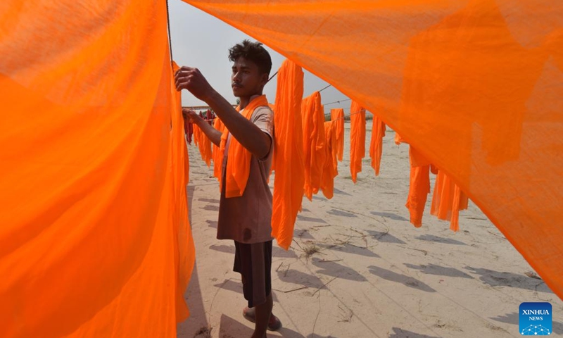A worker dries colored cloth at a factory in Narayanganj, Bangladesh, Oct. 17, 2023.(Photo: Xinhua)