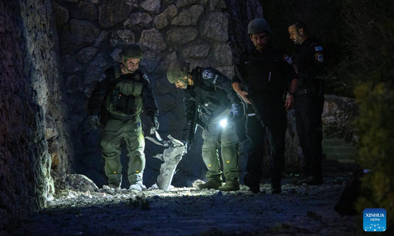 Israeli police handle the remains of a rocket fired from Lebanon, in Kiryat Shmona, northern Israel bordering Lebanon, on Oct. 18, 2023. Lebanon's Hezbollah said on Wednesday it has launched several attacks on Israeli targets with guided missiles. In a statement, the Shiite militant group said it targeted three Israeli sites with missiles, including a center for Israeli soldiers and a surveillance and reconnaissance system south of Al-Manara in northern Israel, causing several casualties. (Photo: Xinhua)