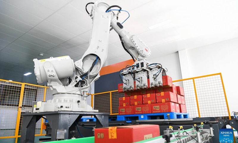 This photo taken on Oct. 16, 2023 shows a robotic arm processing Zhacai (pickled mustard tubers) products at an intelligent production workshop of Chongqing Fuling Zhacai Group Co., Ltd. in southwest China's Chongqing Municipality. The history of pickle-making in Chongqing's Fuling, a major pickle production base, dates back more than 150 years. The district's traditional method of producing preserved mustard tubers was listed as a state-level intangible cultural heritage in 2008.(Photo: Xinhua)