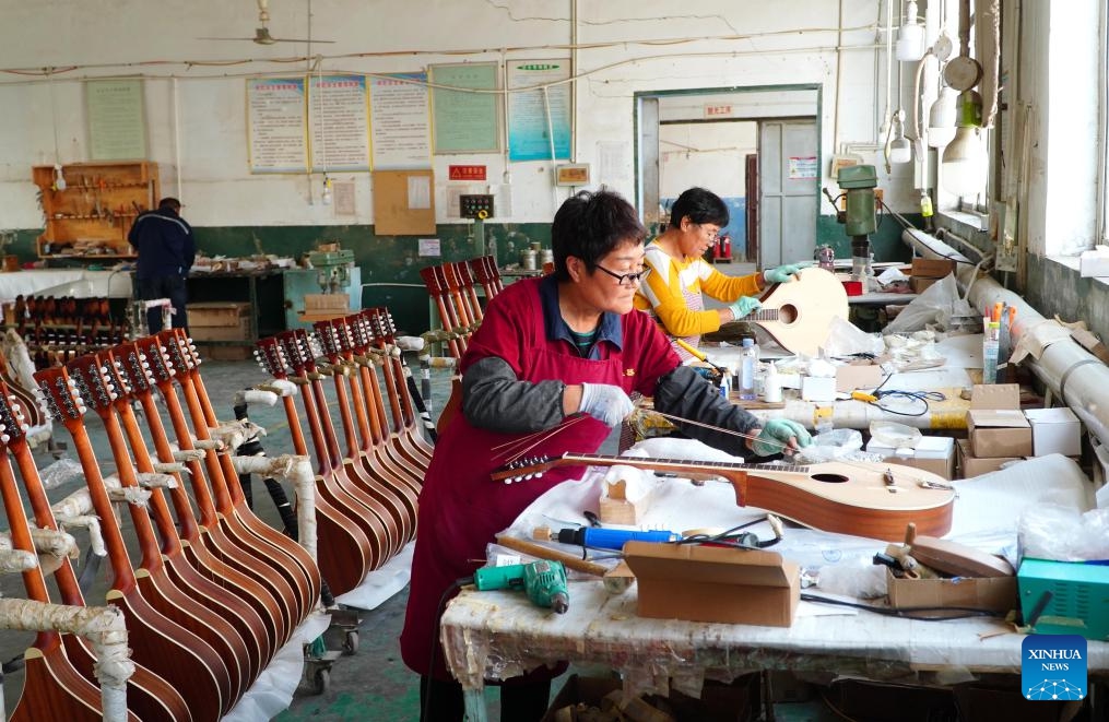 Staff members process musical instruments at Tangwu Town of Changle County, east China's Shandong Province, Oct. 17, 2023. Tangwu Town, a town boasting musical instrument production, possesses 108 musical instrument manufacturing and musical instrument accessory processing enterprises, employing over 5000 people. They produce 2 million musical instruments and 5 million instrument accessories annually, generating a main business revenue of 1 billion yuan (about 140 million U.S. dollars).(Photo: Xinhua)