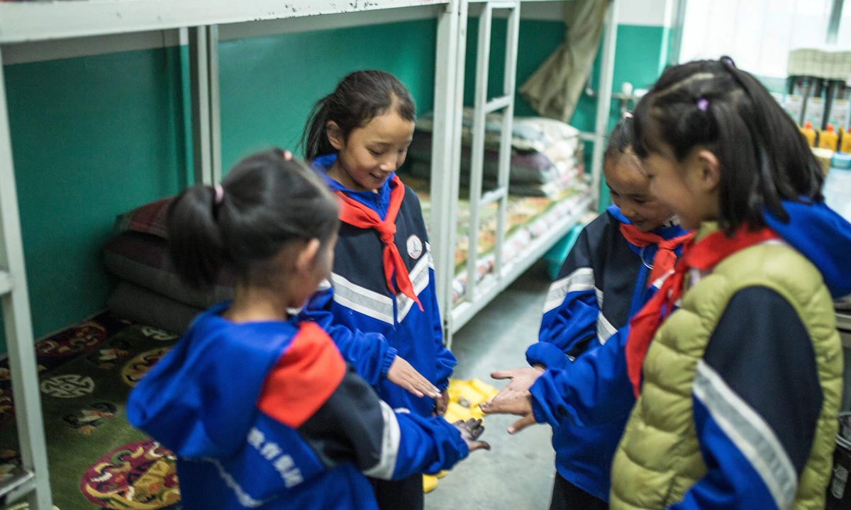 Students play games in a dormitory room at the Sinopec Primary School on October 13, 2023. Photo: Shan Jie/GT