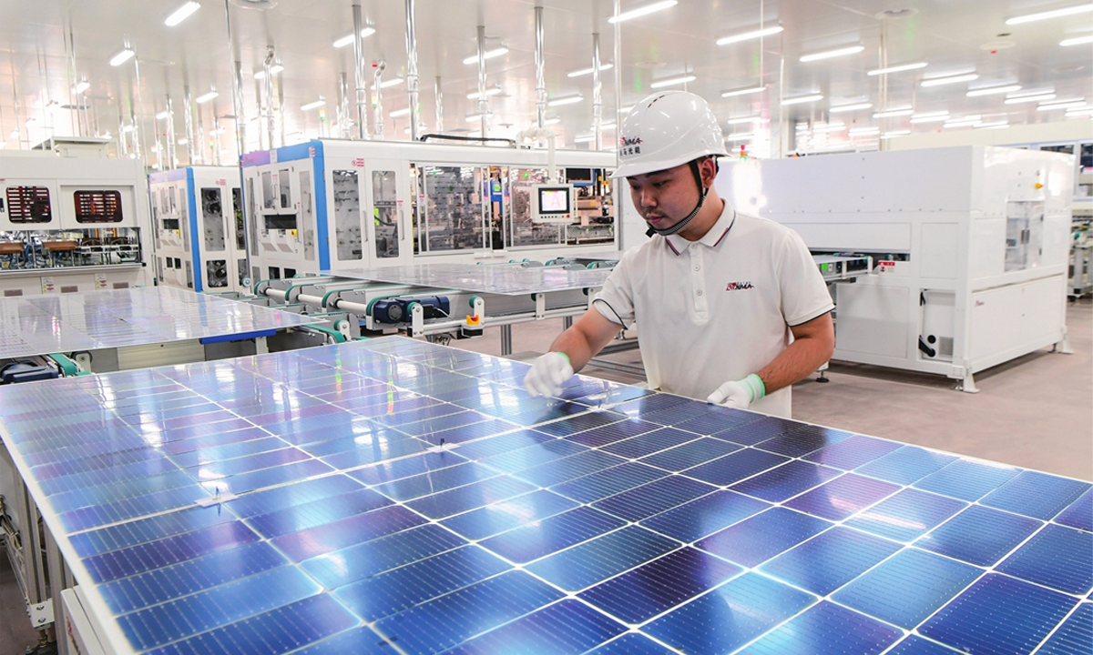 A worker makes photovoltaic parts at a workshop in Jinhua, East China's Zhejiang Province on October 15, 2023. Photo:VCG
