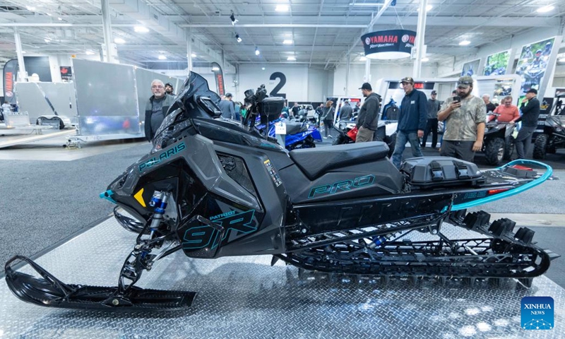People look at a Polaris snowmobile during the 2023 Toronto International Snowmobile, ATV & Powersports Show in Mississauga, the Greater Toronto Area, Canada, on Oct. 21, 2023. Showcasing new snowmobile and ATV line-ups from major manufacturers around the world, the annual show is held here from Oct. 20 to 22. (Photo: Xinhua)
