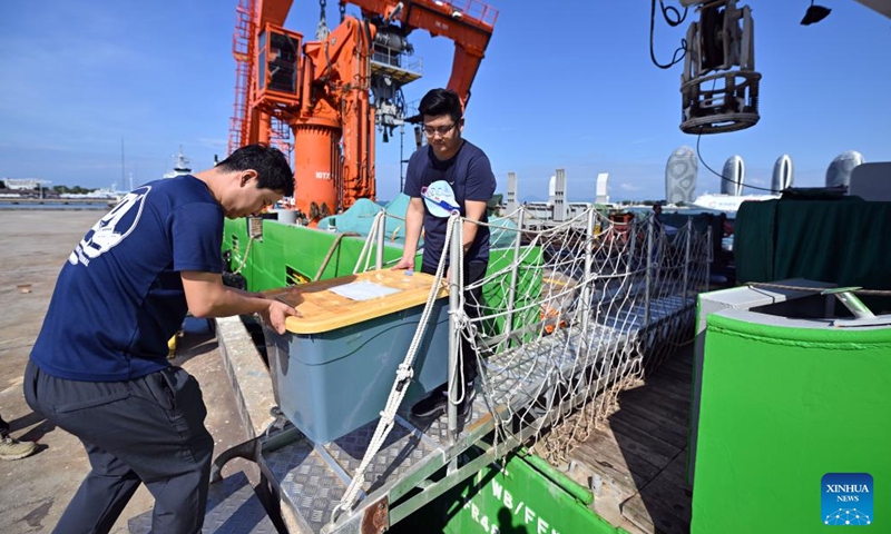 Workers carry cultural relics unearthed from ancient shipwrecks discovered in the South China Sea, Oct. 10, 2023. (Photo: Xinhua)