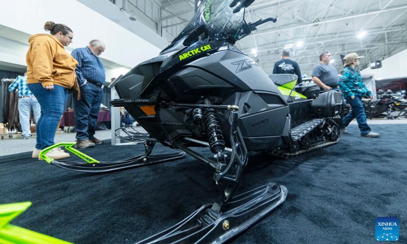 People look at an Arctic Cat snowmobile during the 2023 Toronto International Snowmobile, ATV & Powersports Show in Mississauga, the Greater Toronto Area, Canada, on Oct. 21, 2023. Showcasing new snowmobile and ATV line-ups from major manufacturers around the world, the annual show is held here from Oct. 20 to 22. (Photo: Xinhua)