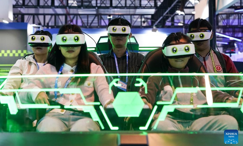 People try VR devices during the 11th China (Wuhu) Popularized Science Products Exposition in Wuhu, east China's Anhui Province, Oct. 21, 2023. The expo kicked off here on Saturday. (Photo: Xinhua)