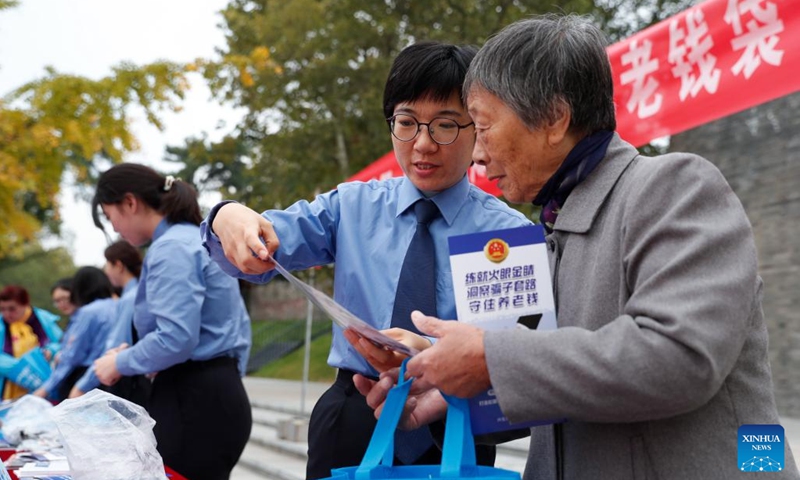 An anti-fraud awareness campaign is held for elders at a park in Xinghua, east China's Jiangsu Province, Oct. 22, 2023. The Chongyang Festival, also known as the Double Ninth Festival, is an annual festival to show respect and care for the elderly throughout China. The festival falls on the ninth day of the ninth Chinese lunar month, which is October 23 this year. (Photo: Xinhua)