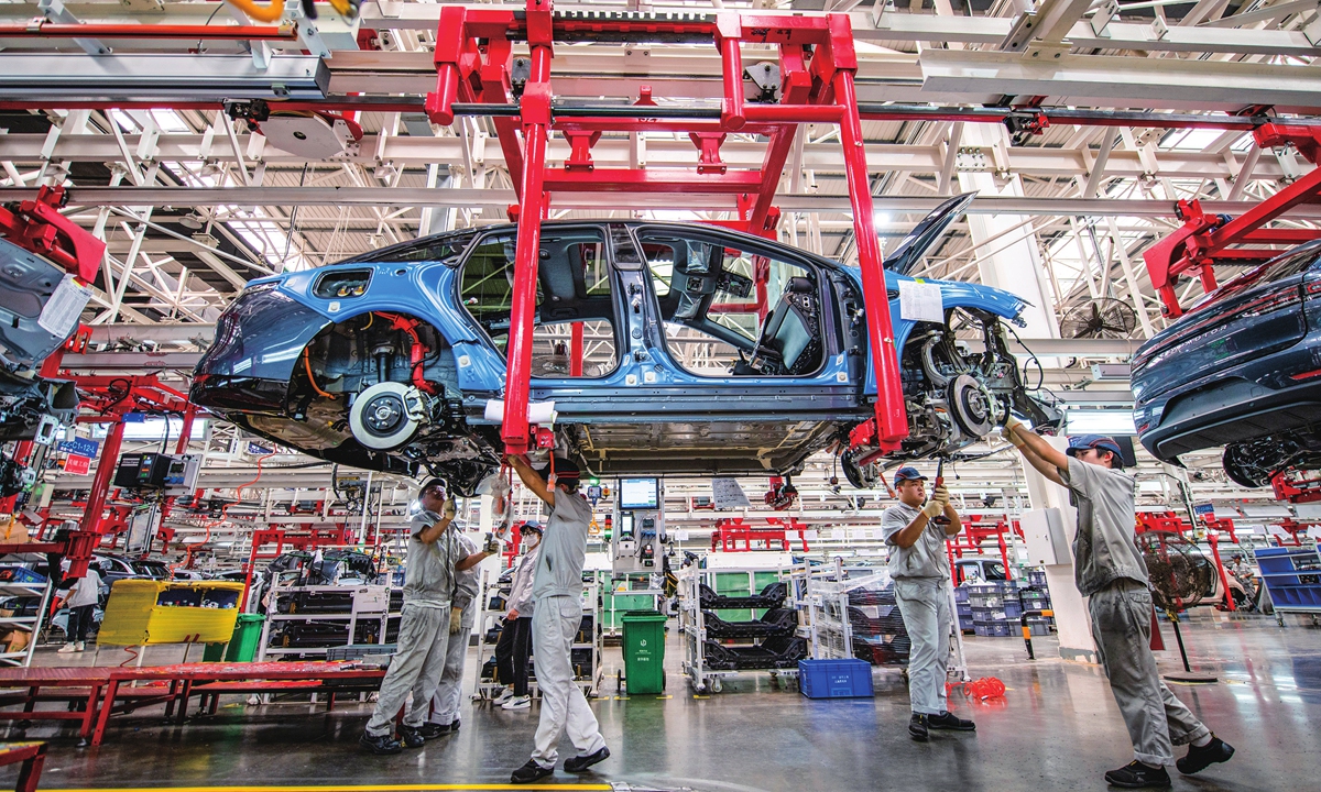 Workers assemble a new-energy vehicle (NEV) in a factory in Jinhua, East China's Zhejiang Province on October 25, 2023. In the first nine months of this year, China exported 825,000 NEVs, data from the China Association of Automobile Manufacturers shows. Photo: VCG