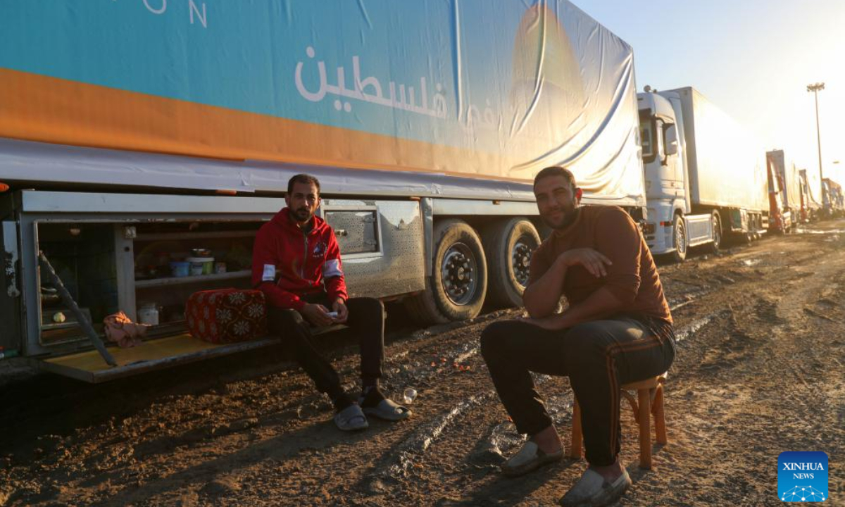 Drivers of trucks loaded with humanitarian aid wait to enter Gaza Strip on the Egyptian side of the Rafah crossing on Nov 30, 2023. A total of 2,781 trucks loaded with humanitarian aid have so far entered the Gaza Strip through the Rafah crossing, the only linking point between Egypt and the Palestinian enclave, Egypt's State Information Service (SIS) said Thursday. Photo:Xinhua