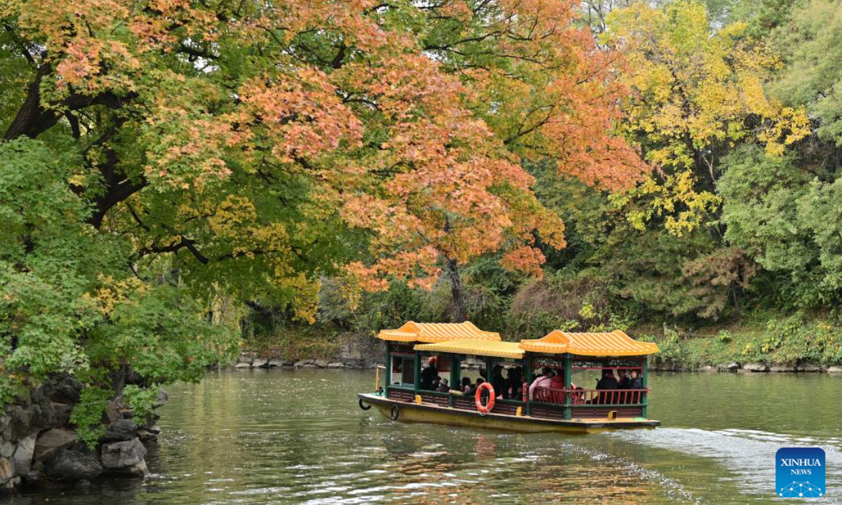 Tourists enjoy the beauty of red leaves by boat at the Summer Palace in Beijing, capital of China, on Nov 3, 2023. Photo:Xinhua