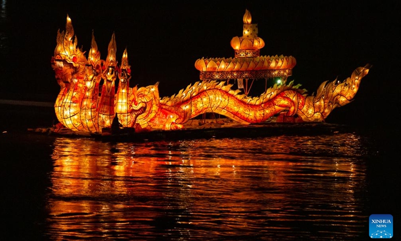 This photo taken on Oct. 30, 2023 shows a light boat floating down the Mekong River in Luang Prabang, Laos. Boun Lai Heua Fai, a light boat festival, was held in the northern Lao world heritage town of Luang Prabang on Monday.(Photo: Xinhua)