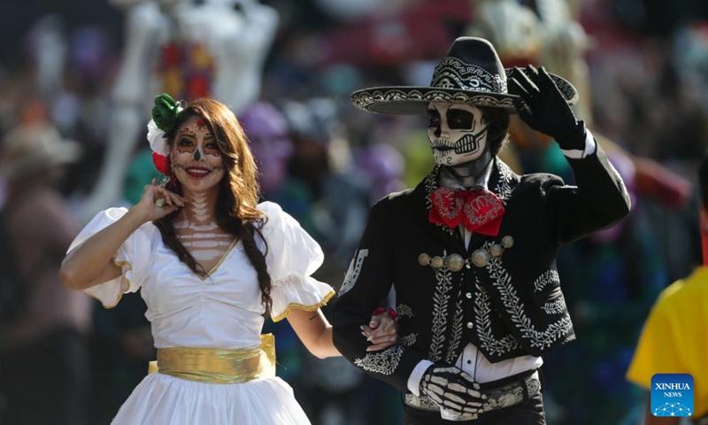 People take part in the Day of the Dead Parade in downtown Mexico City, capital of Mexico, on Nov. 4, 2023. (Photo: Xinhua)