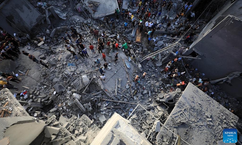 People check the damage caused by an Israeli strike at the al-Mughazi refugee camp in Deir Balah of the central Gaza Strip on Nov. 5, 2023. At least 37 Palestinians were killed and more than 100 others injured on Sunday in a massive Israeli attack on the al-Mughazi refugee camp in the central Gaza Strip, the Gaza-based Health Ministry said. (Photo: Xinhua)
