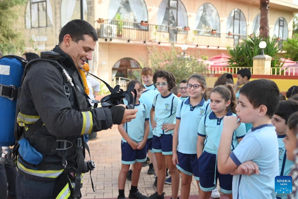 A staff member of the civil protection department briefs children during a tsunami response exercise in Marsaxlokk, Malta, on Nov. 7, 2023. Malta conducted the tsunami response exercise here on Tuesday, simulating a situation of widespread tsunami threat throughout the Eastern and Central Mediterranean.(Photo: Xinhua)