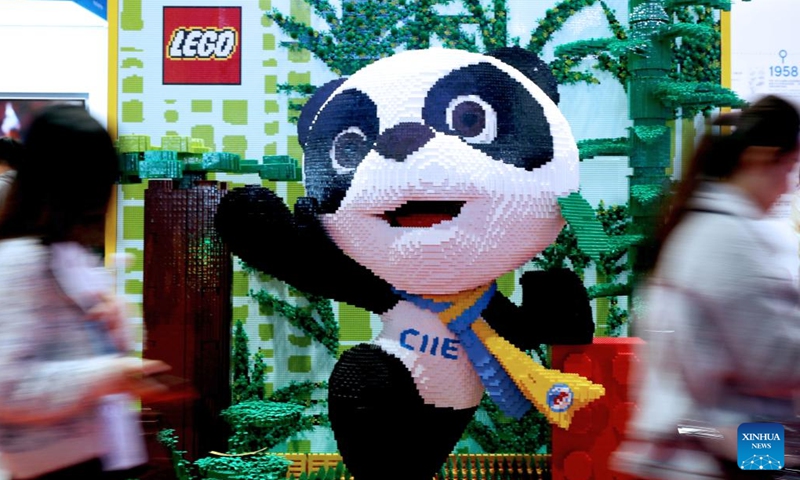Visitors walk by a figure of 3D Jinbao, mascot of the China International Import Expo (CIIE), built by LEGO bricks at the booth of Danish toy giant LEGO Group during the second CIIE in Shanghai, east China, Nov. 9, 2019. The LEGO Group has participated in the CIIE for six consecutive years. The Danish toy giant released four new toy sets on Monday during the sixth CIIE.(Photo: Xinhua)