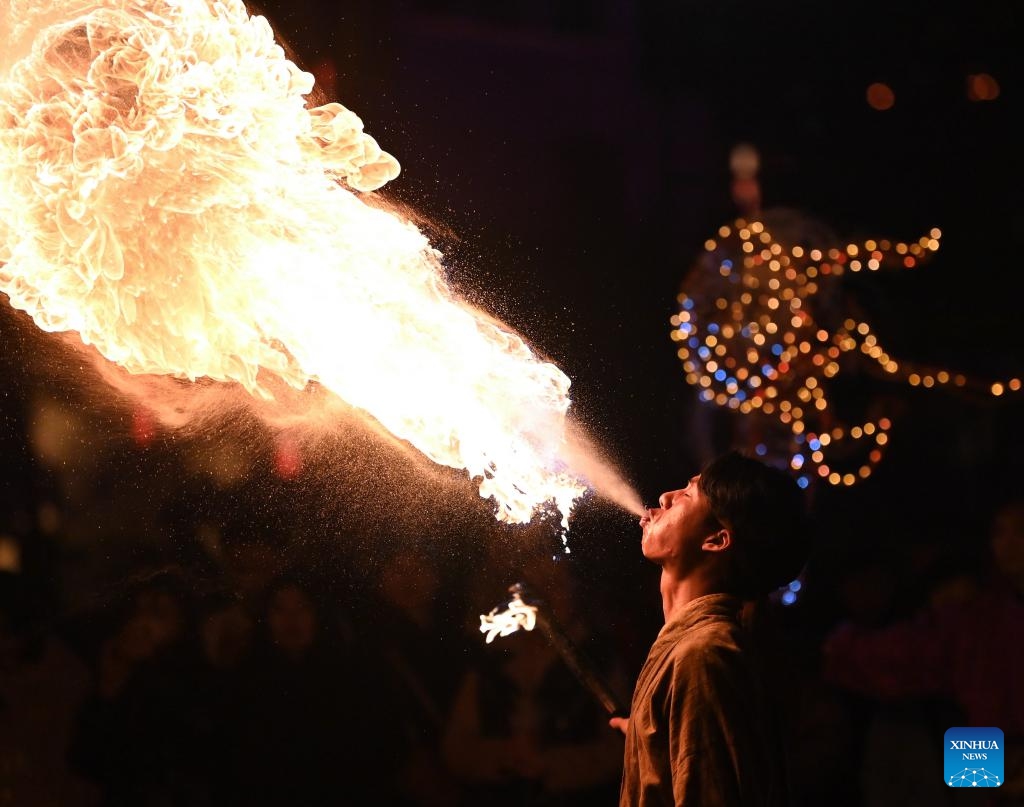 A man performs fire-breathing at the Yotkan cultural scenic spot in Hotan County, northwest China's Xinjiang Uygur Autonomous Region, Nov. 7, 2023. The Yotkan cultural scenic spot is a small town featuring unique attraction that integrates culture, tourism, commerce and leisure. Performances elaborating its historical events are provided to tourists every night, allowing them to be immersed in the splendor of the ancient Silk Road.(Photo: Xinhua)