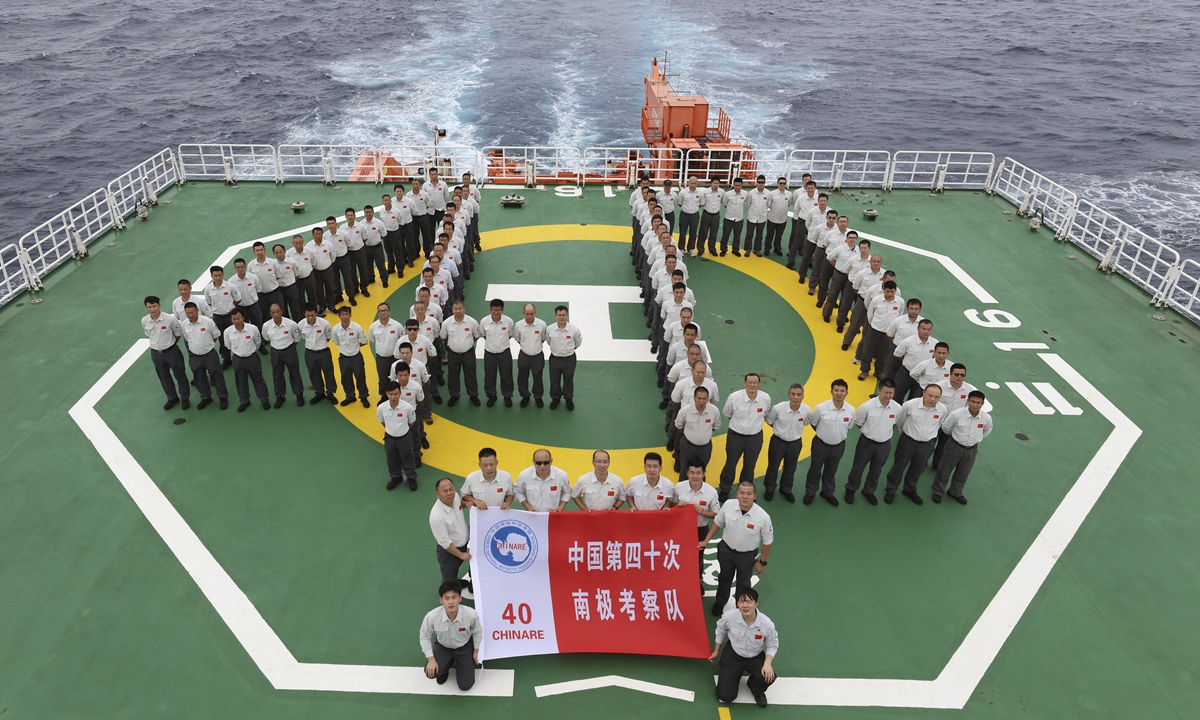 Team members stand to form the figure 